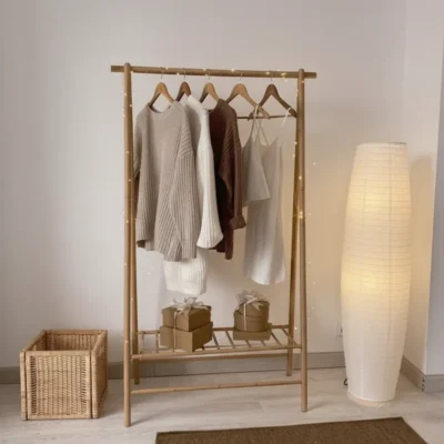 Orienta is a contemporary wooden clothes hanger by Living, made from light natural wood. Includes a hanging area and a lower storage shelf. dimensions: 160 cm (H) × 100 cm (W) × 45 cm (D). Ideal for bedrooms, dressing rooms, or entryways, adding a natural and elegant touch to the décor.